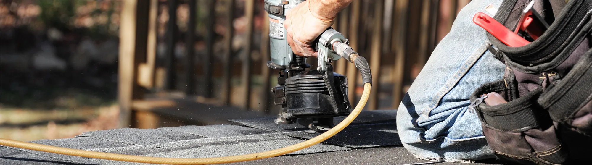 Biebel Bros roofer running an air nailer on a new shingle roof